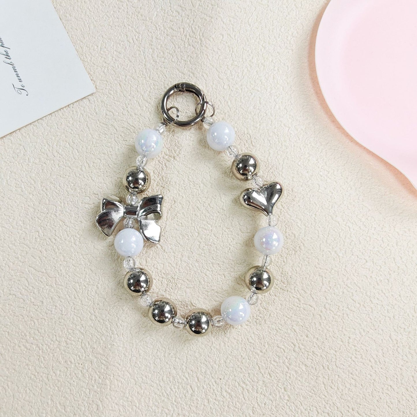 Metallic Bow & Heart Charm Strap – Silver Glossy Beads with Cute Accents | FAMAKA
